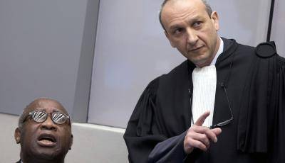Laurent Gbagbo looks on next to his lawyer Emmanuel Altit before the start of his trial at the ICC on 28 January 2016. Photo by Getty Images.
