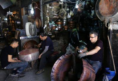 Syrian men making copper pots. Damascus, February 2016. Photo: Getty Images.