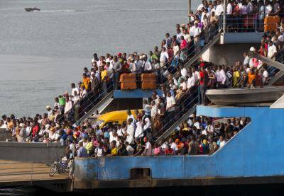 Magogoni ferry arrives at city full of commuters, Dar es Salaam, Tanzania. Photo: Charles Bowman/Getty Images.

