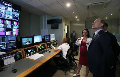 Vladimir Putin visits the English-language service of Russia Today, now renamed RT. Photo: Getty Images.