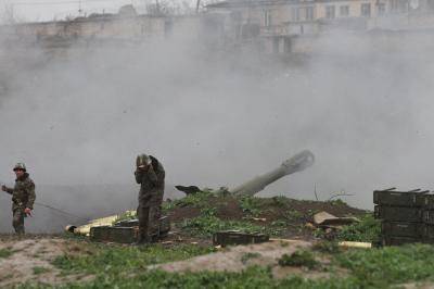 Armenian soldiers fire an artillery shell towards Azerbaijani forces from their positions in the town of Martakert on 3 April 2016. Photo by Getty Images.