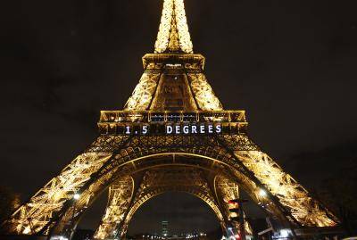 The slogan '1.5 Degrees' is projected on the Eiffel Tower as part of the World Climate Change Conference 2015 (COP21) on 11 December 2015 in Paris, France. Photo by Getty Images.