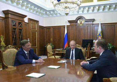 Vladimir Putin (centre) unexpectedly replaces his close ally and powerful chief of staff Sergei Ivanov (left) with Anton Vaino (right), an ex-diplomat who served as Ivanov's deputy. Photo by ALEXEI DRUZHININ/AFP/Getty Images.