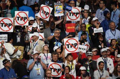 Protesters state their position on the Trans-Pacific Partnership (TPP) during the first day of the Democratic National Convention in Philadelphia on Monday 25 July 2016. Photo via Getty Images.