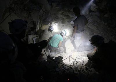 Syrian civil defence volunteers, known as the White Helmets, search amid the rubble of destroyed buildings following an air strike on the rebel-held neighbourhood of Aleppo, on October 4, 2016. Photo: Getty Images.