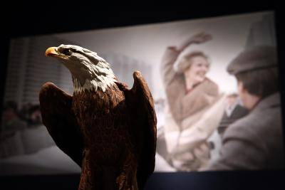 An American bald eagle model gifted to Margaret Thatcher by Ronald Reagan in front of a photograph of Thatcher. Photo by Getty Images.