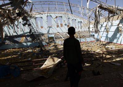 A boy inspects the damage at a sports hall in Sanaa, Yemen on January 19, 2016. Photo by Getty Images.