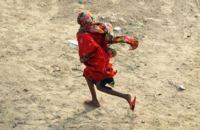 A girl runs to get a cooked meal at a camp for Somalis displaced by famine in 2011 in Mogadishu. Photo: Getty Images.