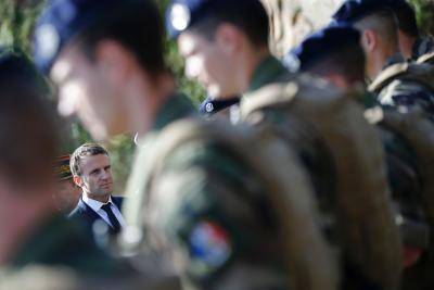 Emmanuel Macron reviews troops during a visit to a submarine base near Brest. Photo: Getty Images.
