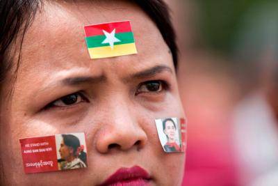 A woman attends a broadcast of the live speech of Myanmar's State Counselor Aung San Suu Kyi at City Hall in Yangon on September 19, 2017. Photo: Aung Kyaw Htet/AFP/Getty Images