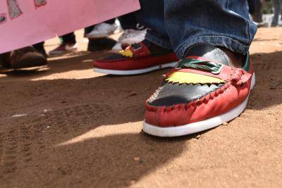 A Biafra supporter wears shoes with the colours of the Biafra flag. Photo: Getty Images.