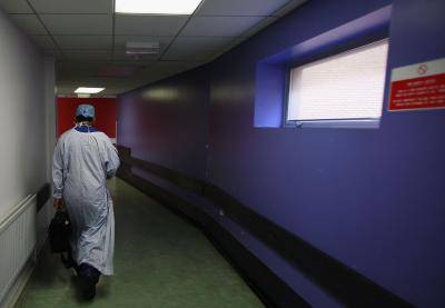 A surgeon leaves the Queen Elizabeth hospital in Birmingham, England. Photo: Getty Images.