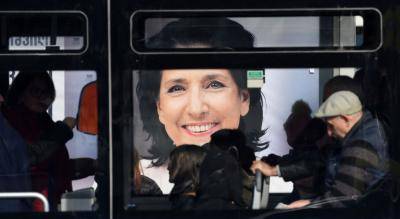 An election poster for Salome Zurabishvili as seen through a bus in Tbilisi on 27 November. Photo: Getty Images.