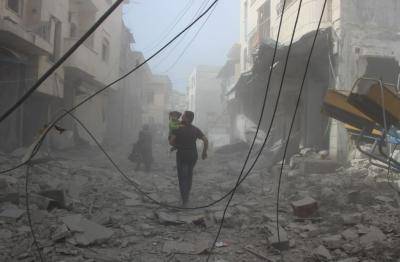 Members of civil right defence conduct a search and rescue operation on destroyed buildings after an airstrike was carried out over the city of Jisr al-Shughur in Idlib province in Syria, on 6 May 2018. Photo: Hadi Harrat/Anadolu Agency/Getty Images.