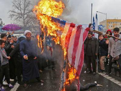 Iranians burn US flags during commemorations of the 40th anniversary of the revolution in Tehran on 11 February. Photo: Getty Images.