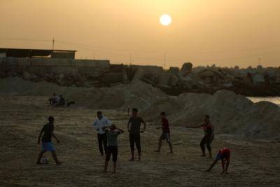 Palestinian youth playing football on a beach in Gaza City in February. Photo: Getty Images.