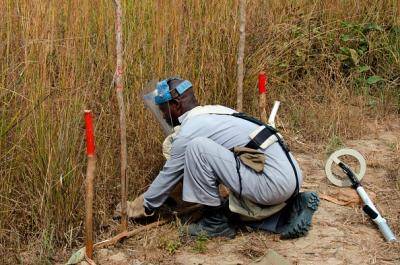 A mine clearance specialist in Angola preparing equipment used to look for unexploded ordnance, May 2012. Photo: Eye Ubiquitous/Contributor/Getty Images.