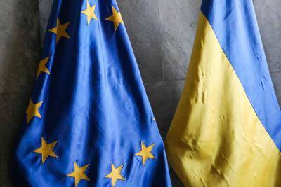 EU and Ukraine flags in Lviv town hall. Photo via Getty Images.