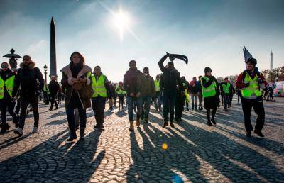Gilets jaunes protestors march through the Place de la Concorde in Paris in November 2018. Photo: Getty Images.