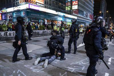 Riot police detain a demonstrator during a protest on Nathan Road in Hong Kong on 20 October. Photo: Getty Images.