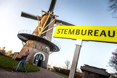 Voters cast their vote as part of the Dutch general elections on March 15, 2017 at a polling station in a mill in Oisterwijk. Photo by ROB ENGELAAR/AFP via Getty Images.