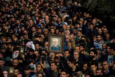 Protesters hold up an image of Qassem Soleimani during a demonstration in Tehran on 3 January. Photo: Getty Images.