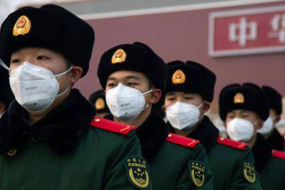 Chinese police officers wearing masks stand in front of the Tiananmen Gate on 26 January. Photo: Getty Images.