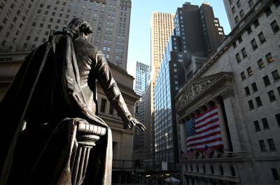 A statue of George Washington is pictured in front of the New York Stock Exchange (NYSE) on 16 March 2020, at Wall Street in New York City. Photo by JOHANNES EISELE/AFP via Getty Images.