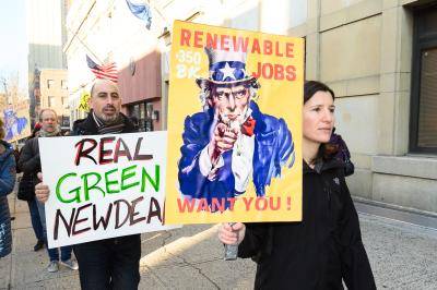 Demonstrators with placards during a protest in New York City to support the Green New Deal. Photo by Michael Brochstein/SOPA Images/LightRocket via Getty Images.
