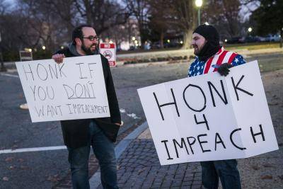 Opposing protests during the House of Representatives debate on whether to charge President Donald Trump with two articles of impeachment. Photo by Sarah Silbiger/Getty Images.