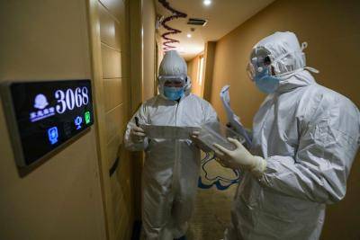 Medical staff on their rounds at a quarantine zone in Wuhan, China. Photo by STR/AFP via Getty Images.