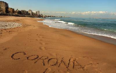 The word Corona written in the sand on the beach in Lebanon's southern city of Saida. amid the spread of coronavirus in the country. Photo by MAHMOUD ZAYYAT/AFP via Getty Images.
