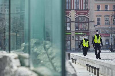 Police officers wearing protective face masks patrol during coronavirus lockdown enforcement in Wroclaw, Poland. Photo by Bartek Sadowski/Bloomberg via Getty Images.