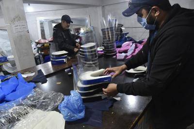 Algerian volunteers prepare personal protection equipment (PPE) to help combat the coronavirus epidemic in the capital Algiers. Photo by RYAD KRAMDI/AFP via Getty Images.
