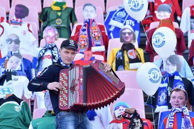 Playing accordion in front of dummy football fans in Brest, Belarus as the country's championship continues despite the COVID-19 outbreak. Photo by SERGEI GAPON/AFP via Getty Images.