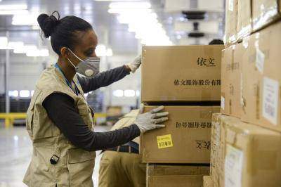 Checking boxes of personal protective equipment (PPE) at the Bole International Airport in Addis Ababa, Ethiopia. Photo by SAMUEL HABTAB/AFP via Getty Images.