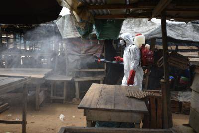 An informal market in the Anyama district of Abidjan, Côte d’Ivoire, is sanitized against the coronavirus. Photo by SIA KAMBOU/AFP via Getty Images.