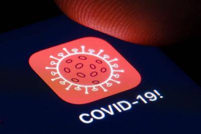 Tracking app for COVID-19 on a smartphone. Photo by Thomas Trutschel/Photothek via Getty Images.