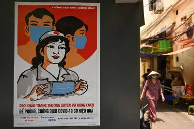 An information poster on preventing the spread of COVID-19 in Hanoi, Vietnam. Photo by MANAN VATSYAYANA/AFP via Getty Images.