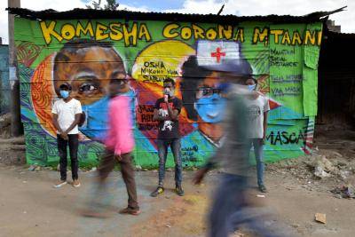 Grafitti artists from Mathare Roots Youth Organisation with their mural helping curb the spread of coronavirus in Nairobi, Kenya. Photo by TONY KARUMBA/AFP via Getty Images.