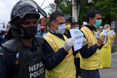 Human rights activists hold placards during a protest against India's newly inaugurated link road to the Chinese border. Photo by PRAKASH MATHEMA/AFP via Getty Images.