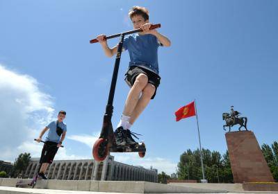 Boys ride scooters during International Children's Day (June 1) at the central Ala-Too Square in Bishkek, Kyrgyzstan. Photo by VYACHESLAV OSELEDKO/AFP via Getty Images.