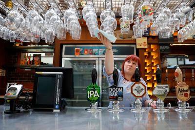 Cleaning glasses in preparation for pubs to reopen following an easing of coronavirus restrictions in England. Photo by TOLGA AKMEN/AFP via Getty Images.