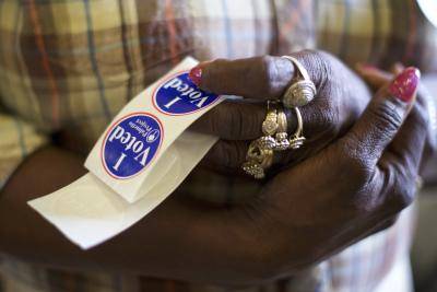 A poll station official holding "I Voted" stickers in South Carolina. Photo by Mark Makela/Getty Images.
