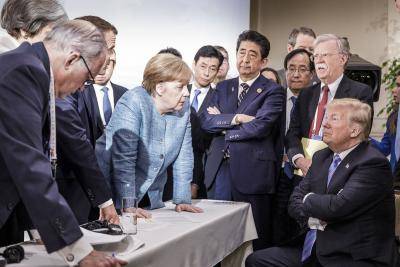 Angela Merkel and other world leaders deliberate with US president Donald Trump at the G7 summit in 2018. Photo by Jesco Denzel /Bundesregierung via Getty Images.