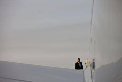 President Barack Obama boards Air Force One