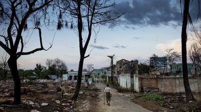 A Muslim man walks among the ruins of his home after a wave of Buddhist violence against Myanmar’s Rohingya community