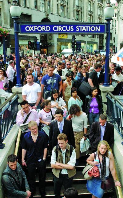Commuters crowd the entrance to London's Oxford Circus underground station.