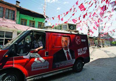 A car decorated with posters of an opposition party candidate </body></html>